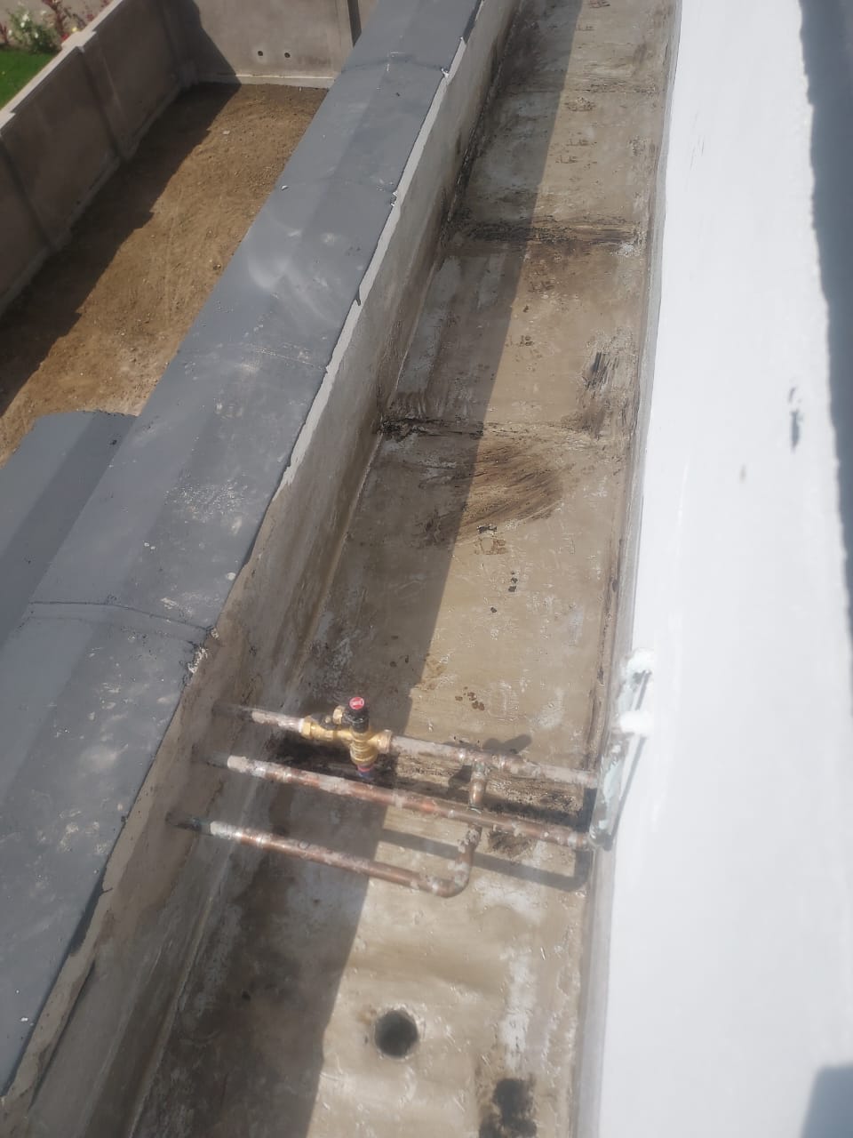 Rooftop channel showing surface condition around pipes